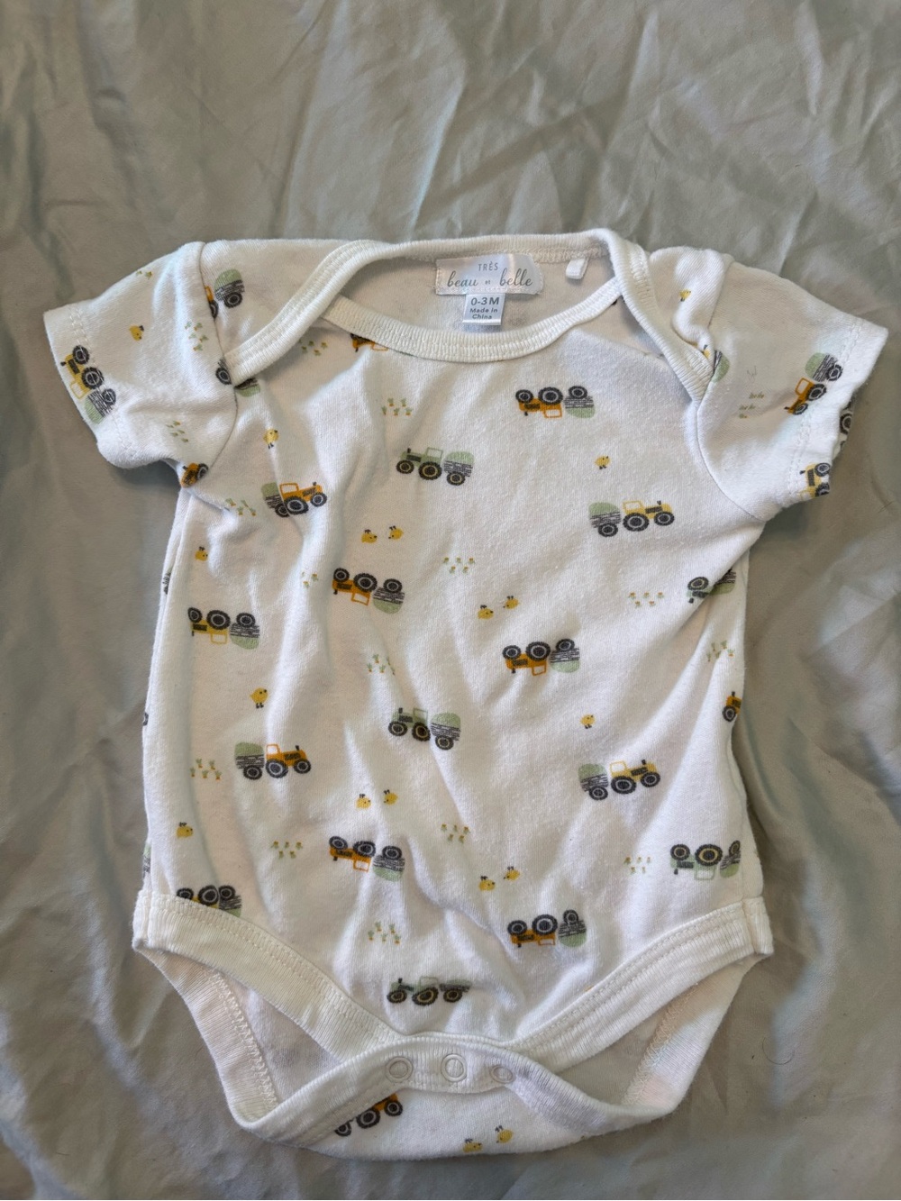 Très Beau et Belle White Cotton Baby Onesie with Tractor Print